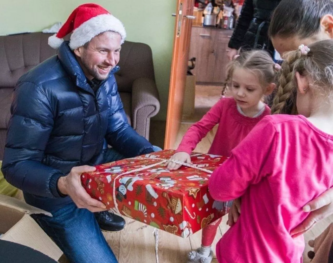Łukasz de Lubicz-Szeliski, wiceprezes Fundacji, wręcza prezenty dzieciom z potrzebujących rodzin. Środki na wsparcie rodzin zostały zebrane podczas charytatywnej kolacji. W sumie 665 tys. zł