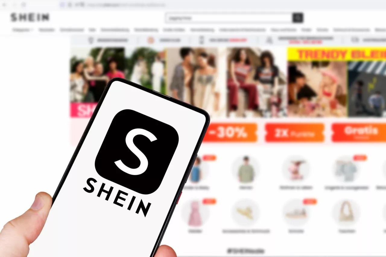 Stuttgart, Germany - May 1, 2024Shein logo online marketplace ecommerce on a mobile phone and computer in Stuttgart, Germany.